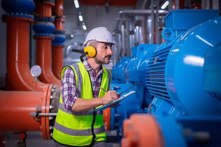 Engineer inspecting compressor equipment